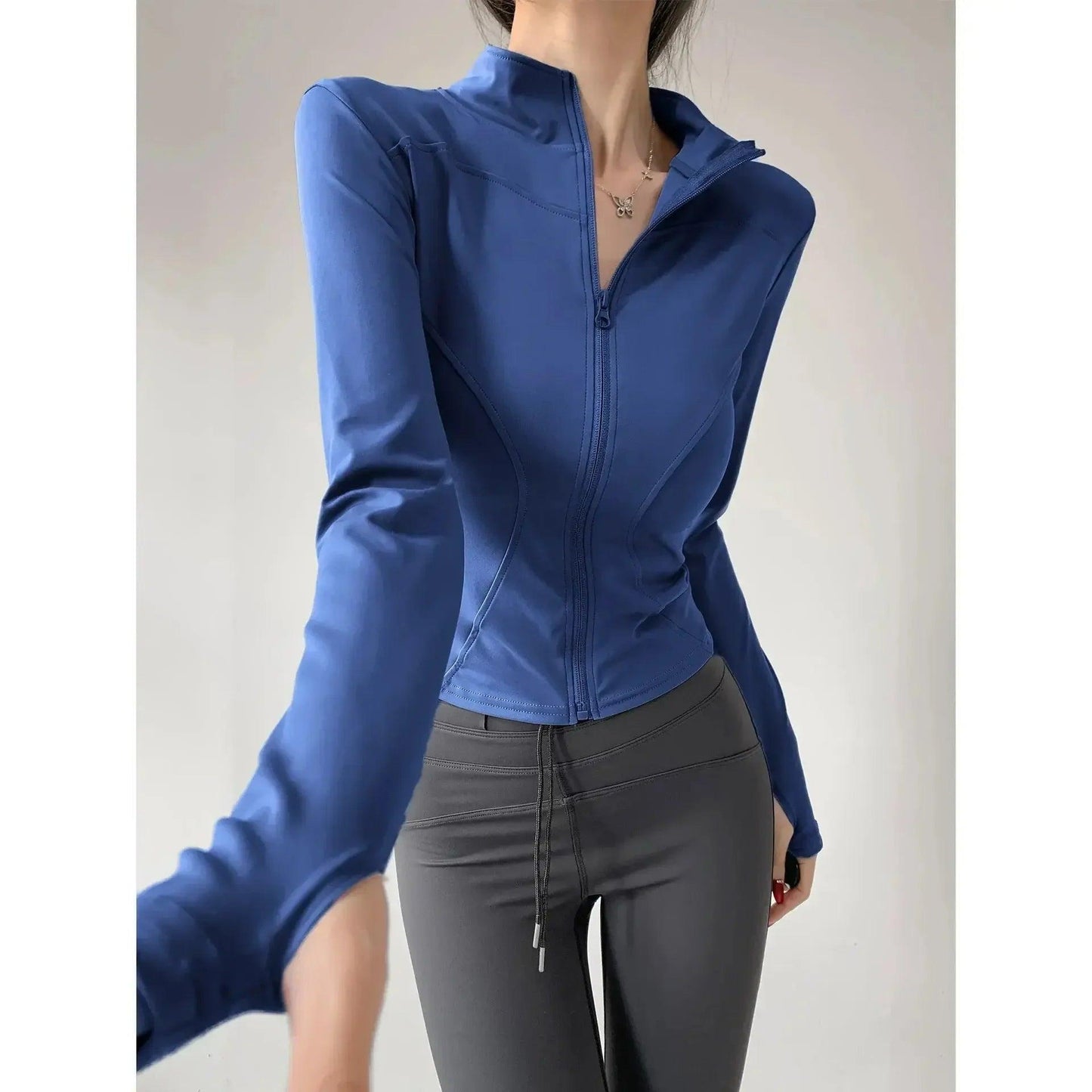 Blue zip-up fitness jacket with gray leggings for women's active wear