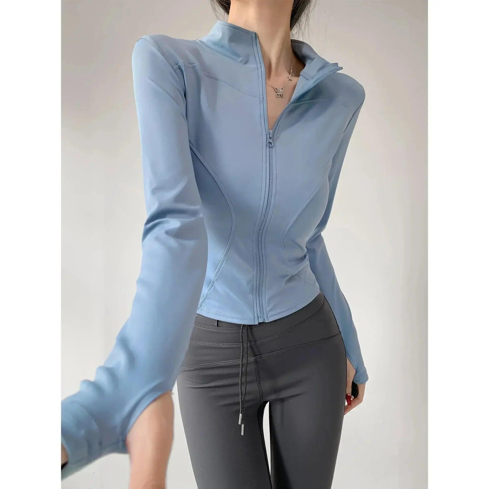 Light blue zip-up fitness jacket with gray leggings for women's active wear