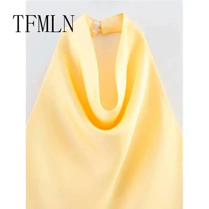 Yellow women's fashion top with deep V-neck and pearl button detail, elegant and stylish