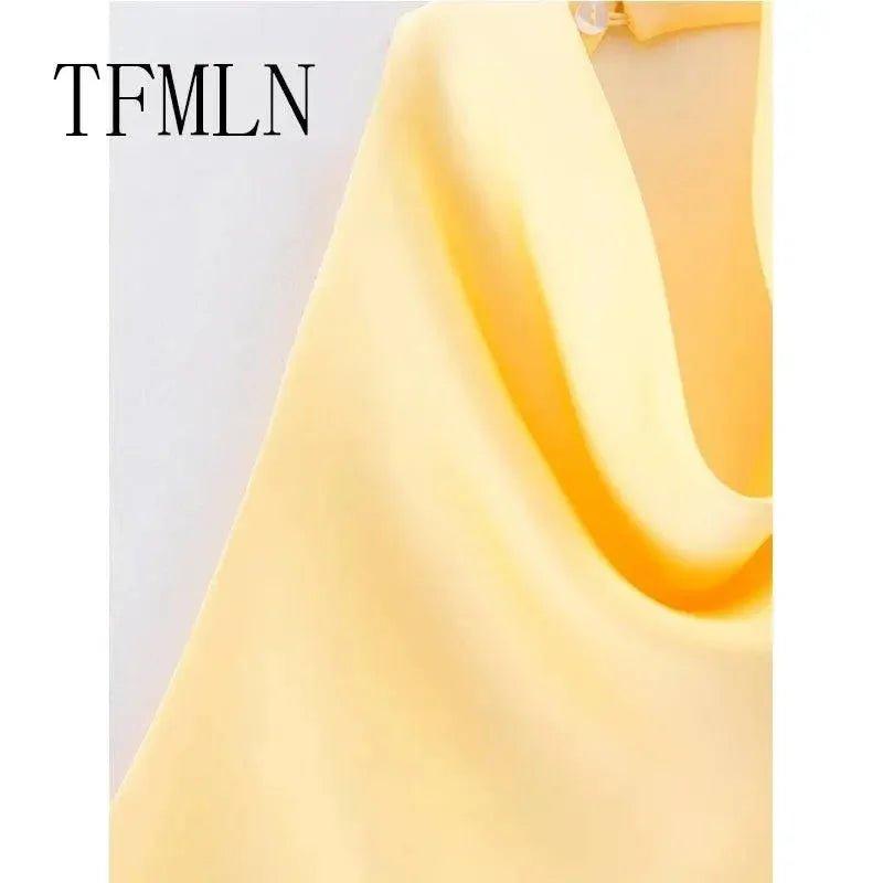 Soft yellow women's fashion top with draped neckline detail