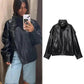 Black faux leather women's jacket with puff sleeves, styled with denim shorts for casual fashion