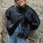 Woman in black leather jacket and ripped jeans, stylish streetwear fashion