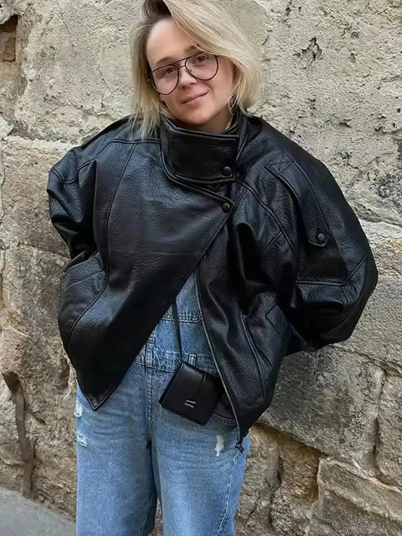 Woman in black leather jacket and ripped jeans, stylish streetwear fashion