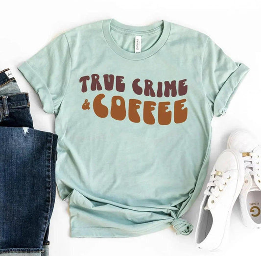 Mint green women's t-shirt with 'True Crime & Coffee' graphic, paired with jeans and white sneakers