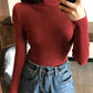Red ribbed turtleneck sweater with high-waisted jeans, women's fashion outfit
