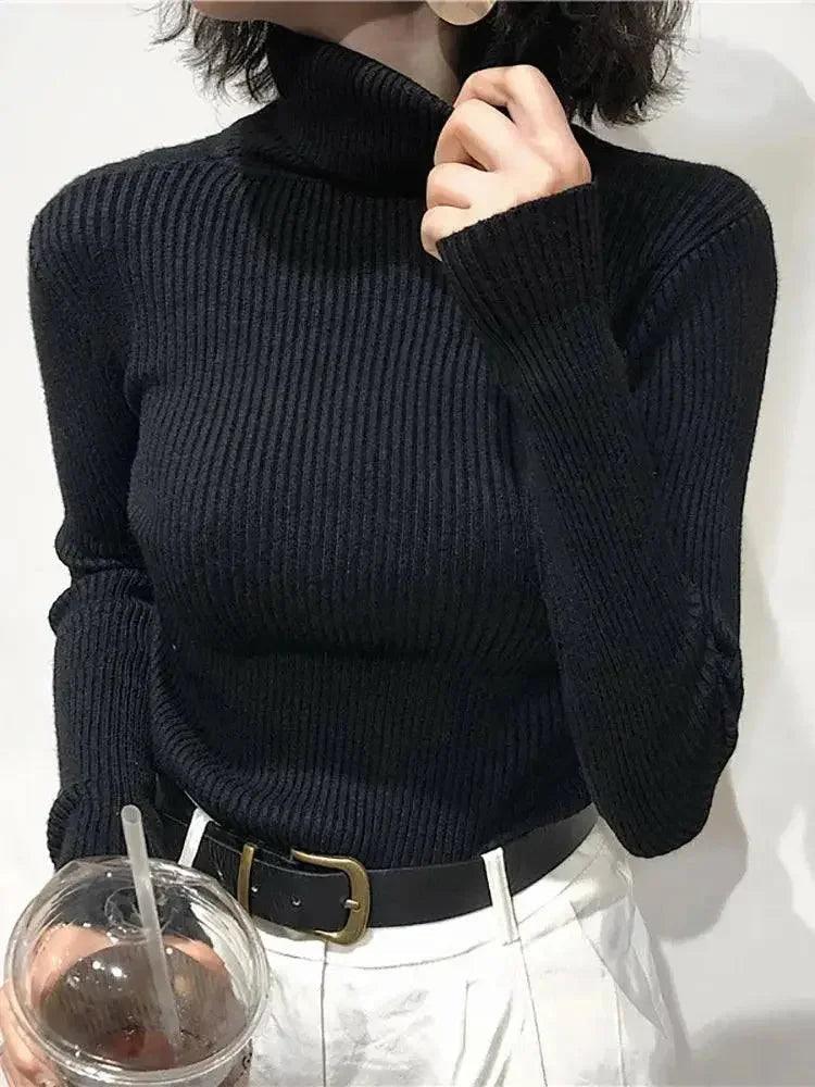 Black ribbed turtleneck sweater for women, stylish fashion top with white pants and belt