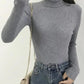 Gray ribbed turtleneck sweater for women, paired with high-waist jeans and chain bag, fashion outfit