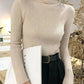 Beige ribbed turtleneck sweater for women, stylish long sleeve top with black pants and belt