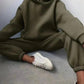 Olive green women's hoodie and jogger set with white sneakers, casual fashion outfit