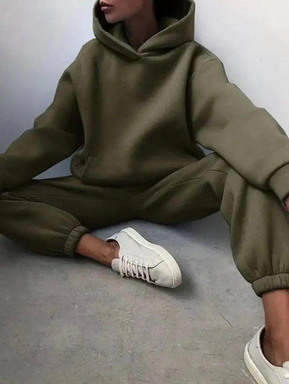 Olive green women's hoodie and jogger set with white sneakers, casual fashion outfit