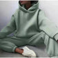 Woman in mint green hoodie and joggers, casual fashion set with white sneakers