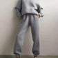 Gray women's hoodie and jogger set with white sneakers, casual fashion outfit