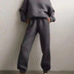 Woman in cozy gray hoodie and matching joggers, casual fashion outfit