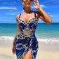 Woman in blue and gold chain print beach dress, sunglasses, seaside fashion