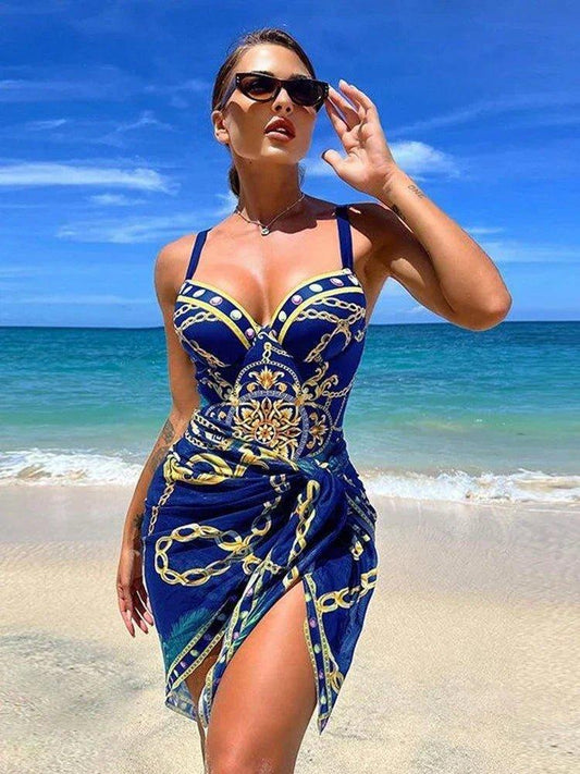 Woman in blue and gold chain print beach dress, sunglasses, seaside fashion