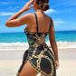 Woman in black and gold chain print beach dress, ocean backdrop, summer fashion