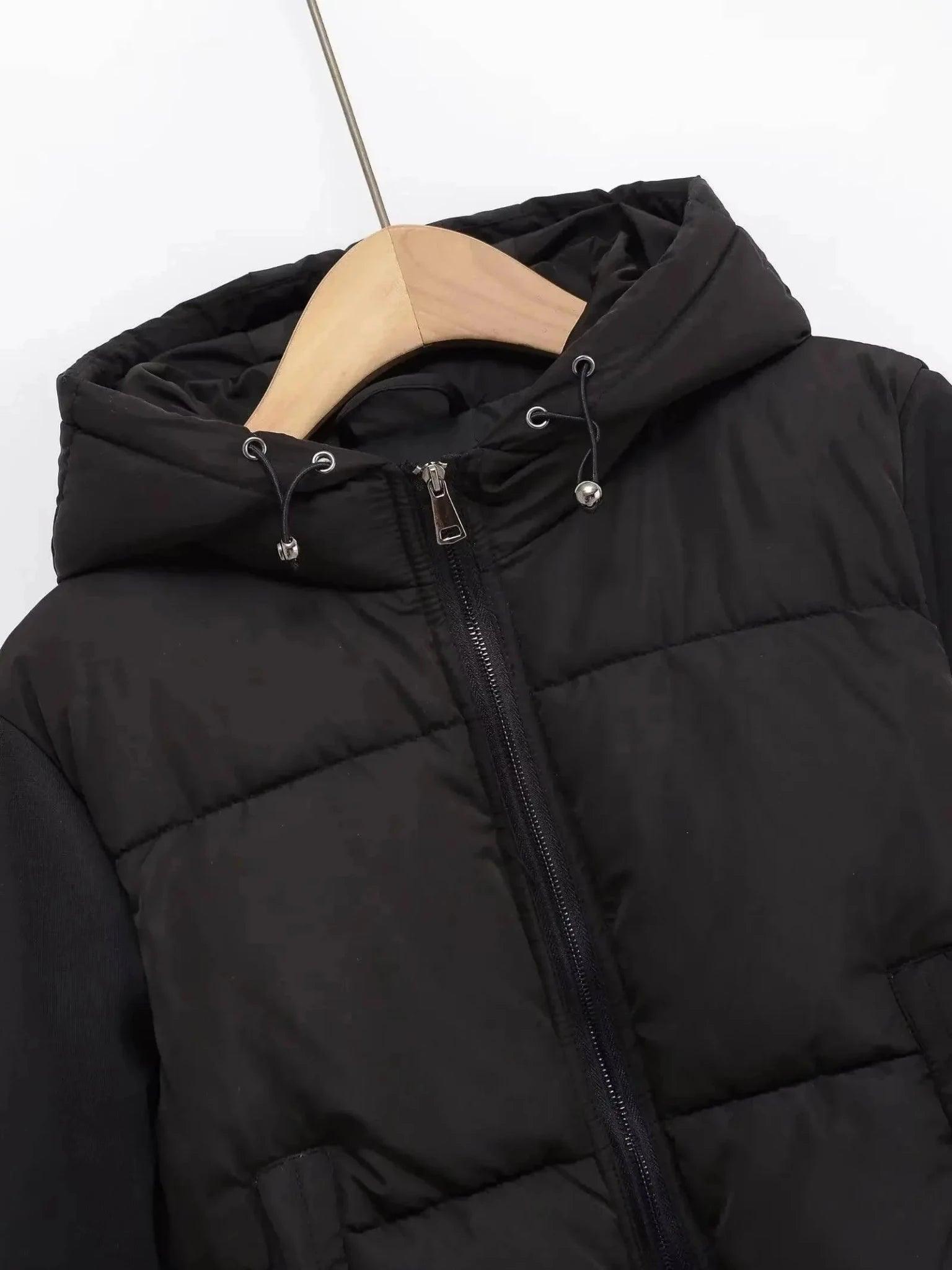 Black puffer jacket with hood and drawstring, women's winter fashion outerwear on hanger