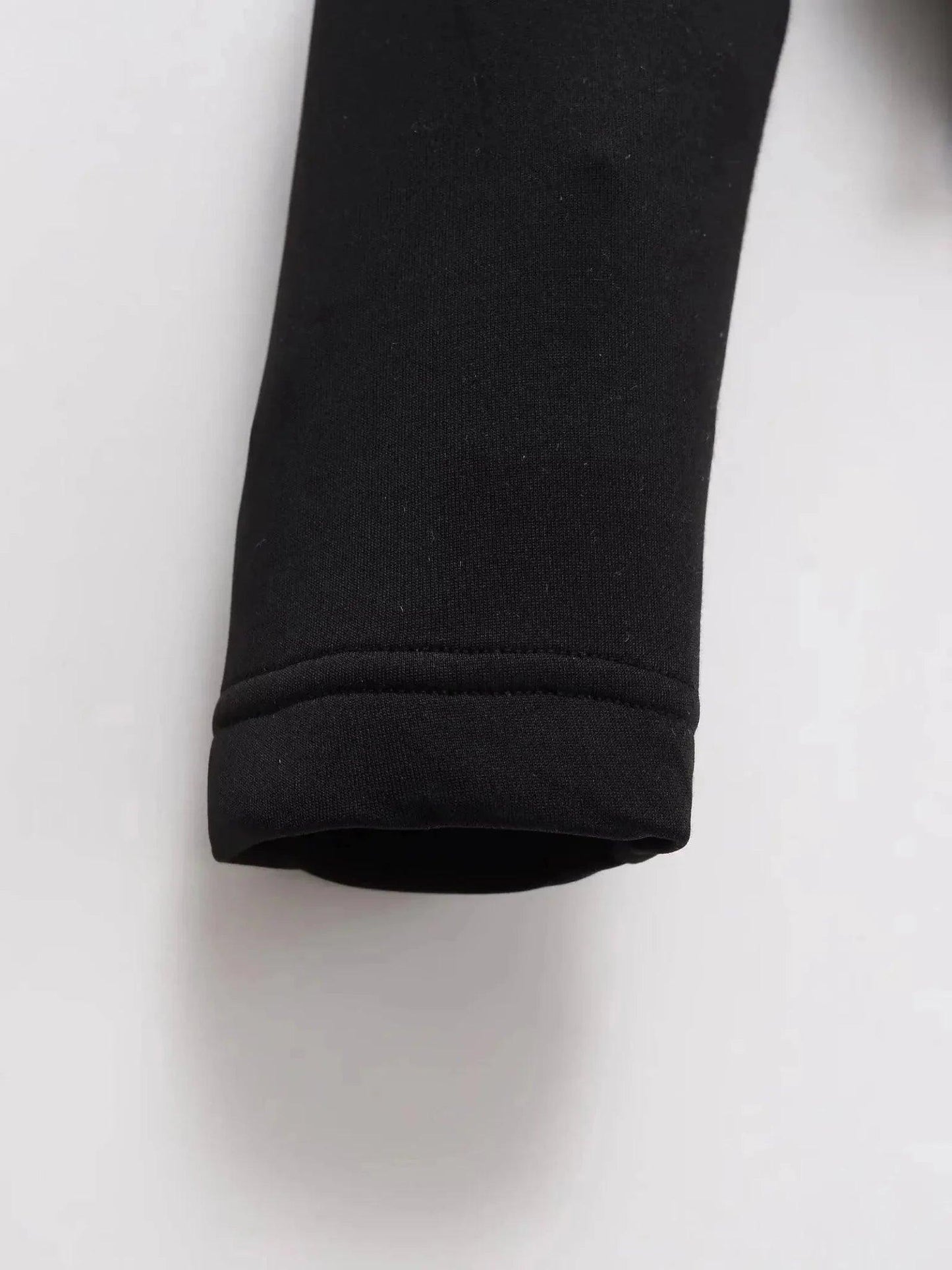 Black long sleeve women's fashion top with ribbed cuff detail