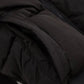Black puffer jacket close-up showing quilted texture and zipper detail, women's fashion outerwear