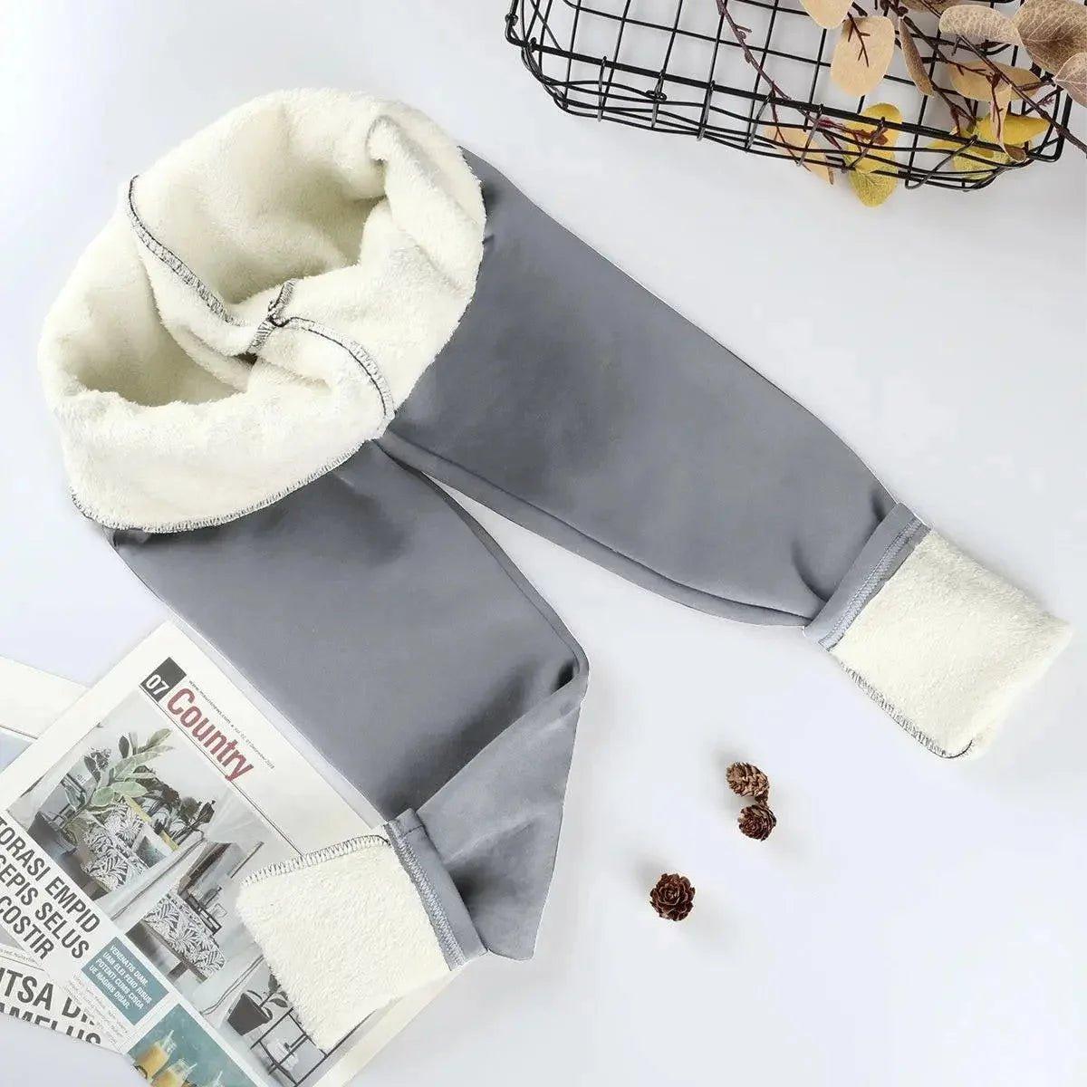 Gray women's fleece-lined joggers with cozy white interior, perfect for winter fashion comfort.