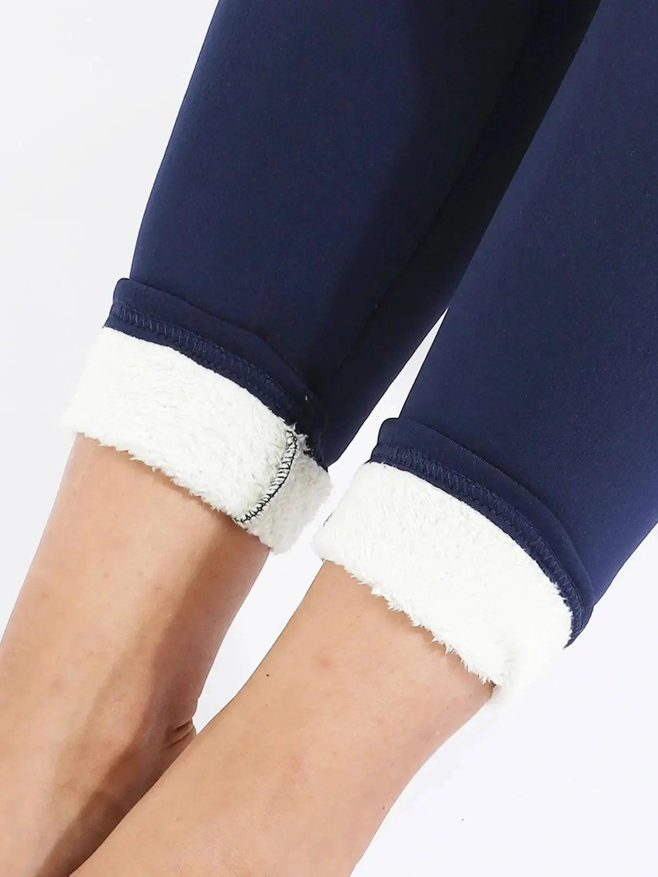 Navy blue women's fleece-lined leggings with cozy white cuffs, perfect for casual fashion and comfort.