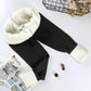 Black women's fleece-lined joggers with cozy white sherpa interior, stylish winter fashion