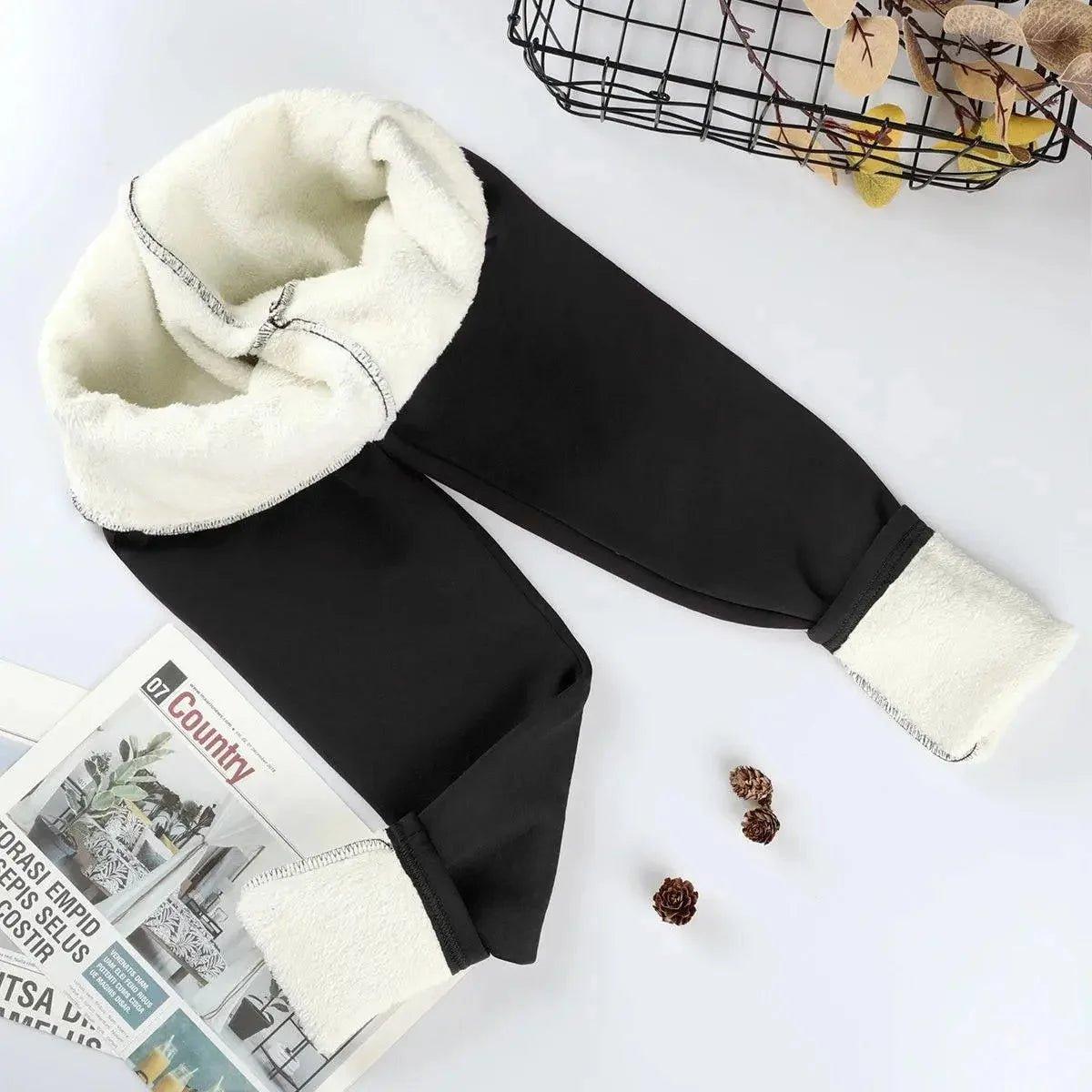 Black women's fleece-lined joggers with cozy white sherpa interior, stylish winter fashion