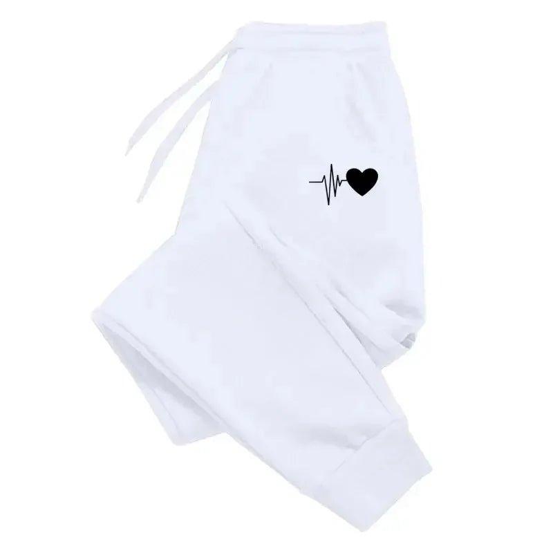White women's joggers with black heartbeat heart graphic, cozy fashion sweatpants