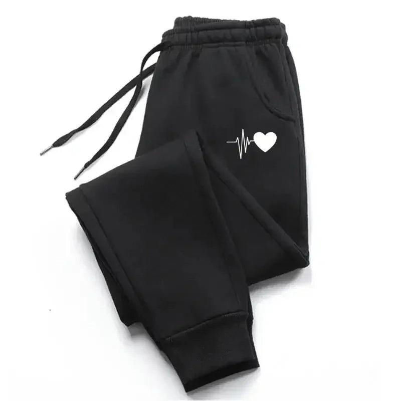 Black women's joggers with white heartbeat heart design, cozy and stylish fashion pants