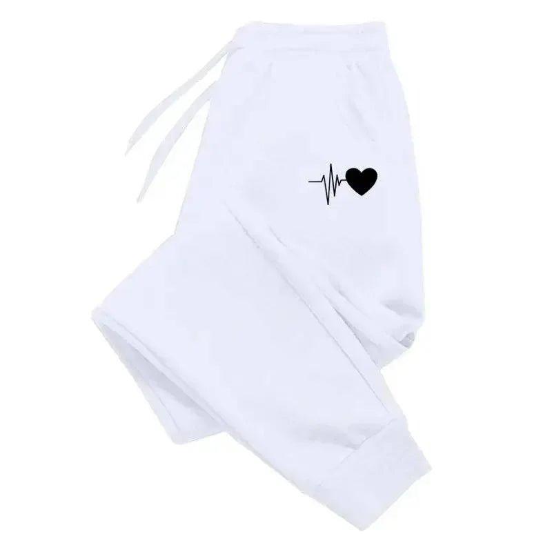 White women's joggers with black heartbeat heart graphic, cozy casual fashion pants