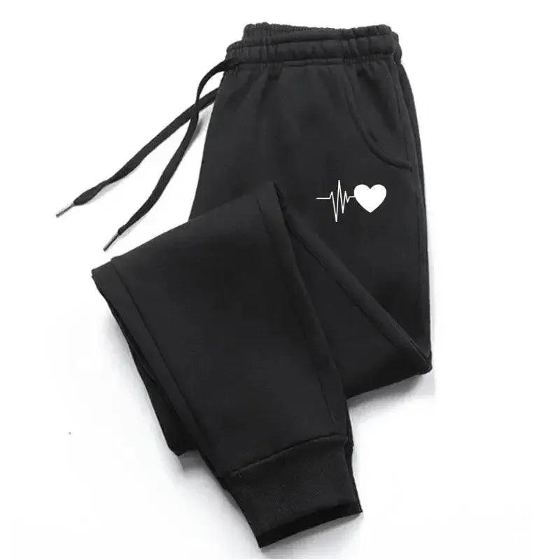 Black women's joggers with white heartbeat heart graphic, cozy casual sweatpants for fashion and comfort