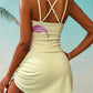 Woman in cream criss-cross back swimsuit with pink floral print, beach style summer fashion