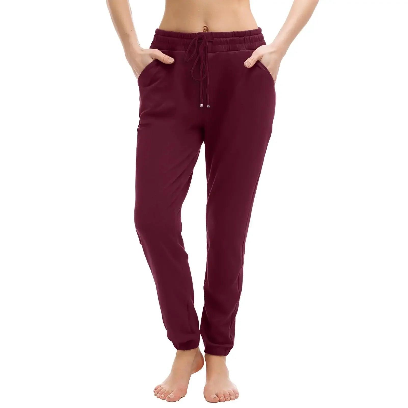 Burgundy women's jogger pants with drawstring waist and side pockets, casual fashion wear