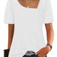 White women's fashion top with puff sleeves, square neckline, and decorative buttons, paired with jeans