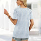 Woman in blue and white striped top with denim shorts, summer fashion outfit