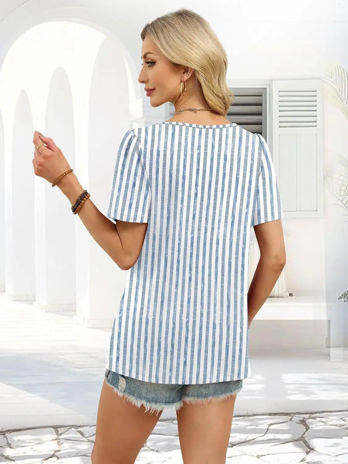 Woman in blue and white striped top with denim shorts, summer fashion outfit