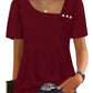 Burgundy women's blouse with puff sleeves, square neckline, and decorative buttons, paired with jeans for casual fashion.