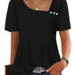 Black women's puff sleeve top with square neckline and button detail, paired with jeans