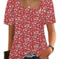 Red floral print women's blouse with puff sleeves and square neckline, paired with jeans