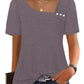 Women's gray short sleeve top with puff sleeves, square neckline, and front buttons, paired with jeans