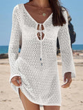 White crochet beach cover-up dress with long sleeves and V-neck tie, perfect for summer fashion
