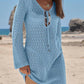 Light blue crochet beach cover-up dress with V-neck tie, worn on sandy beach