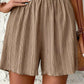 Beige pleated women's shorts with elastic waist, stylish summer fashion