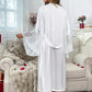 White lace-trimmed robe for women, elegant sleepwear with bell sleeves, cozy bedroom setting