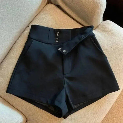 Black high-waisted women's fashion shorts with front zipper detail, styled on beige sofa