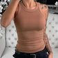 Woman wearing fitted brown tank top with ruched detail, paired with black jeans and belt, casual fashion style