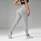 Woman in gray ribbed high-waist leggings and black sports bra, fitness fashion