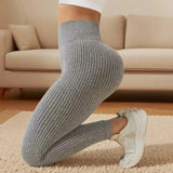 Gray ribbed women's leggings with white sneakers, cozy living room fashion