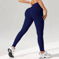 Navy blue ribbed high-waist leggings for women, paired with white sneakers, perfect for fitness and fashion.