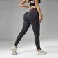 Woman in gray ribbed high-waisted leggings and black sports bra, fitness fashion